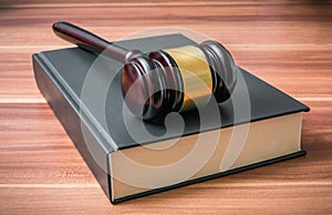 Wooden gavel on book. Justice and law concept