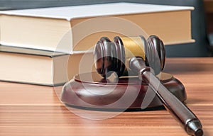 Wooden gavel and books in background. Law and justice concept