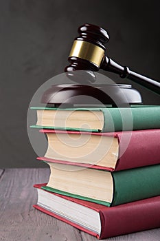 Wooden gavel and books on wooden table - law and auction concept