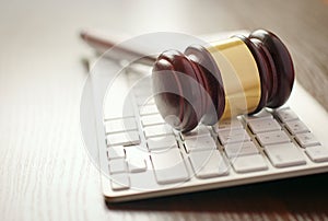 Wooden gavel on a computer keyboard