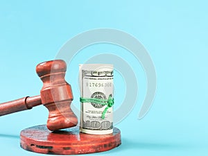 Wooden gavel and fake money isolated on blue background.