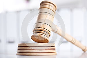 Wooden gavel and folders on wooden table, close up