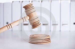 Wooden gavel and folders on wooden table, close up