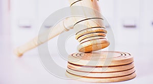 Wooden gavel and folders on wooden table, close up