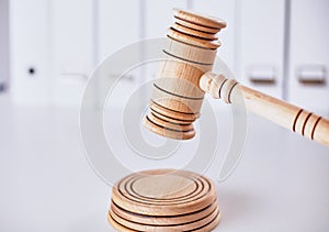 Wooden gavel and folders on wooden table, close up