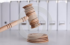 Wooden gavel and folders on wooden table, close up