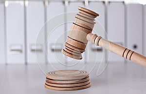 Wooden gavel and folders on wooden table, close up