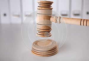 Wooden gavel and folders on wooden table, close up