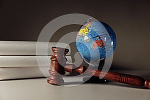 Wooden gavel and globe on the desk. International law and justice court concept