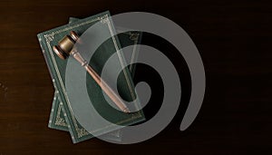 Wooden gavel, judges hammer or mallet on books over wood table background, law, legal or court symbol or concept, top view flat