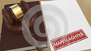 Wooden gavel and MANSLAUGHTER stamp on the paper. Court related 3d rendering photo