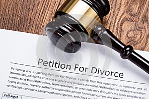 Wooden Gavel On Petition For Divorce Paper