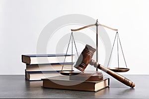 Wooden gavel, scales of justice and books