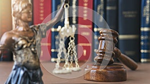 Wooden gavel, scales of lady and books on table. Justice concept