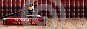 Wooden Gavel And Soundboard On Consumer Protection Law Book