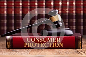 Wooden Gavel And Soundboard On Consumer Protection Law Book photo