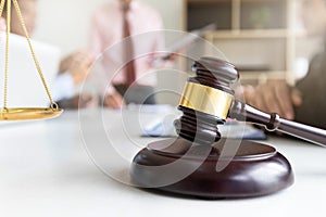 Wooden gavel on table in lawyer\'s office.