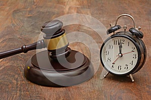 Wooden Gavel with time clock Delay Justice concept photo