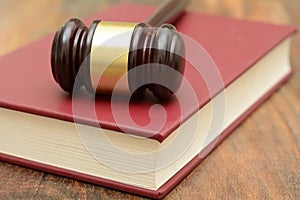 Wooden Gavel on top of a law book in court