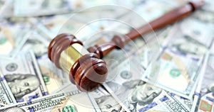 Wooden gavel with us dollar on table. closeup