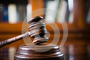 Wooden gavel on wooden table,legal books background