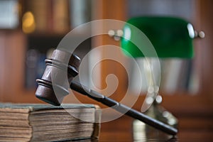 Wooden gavel on wooden table,legal books background