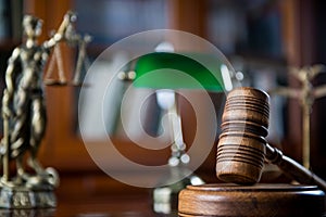 Wooden gavel on wooden table,legal books background