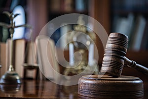 Wooden gavel on wooden table,legal books background