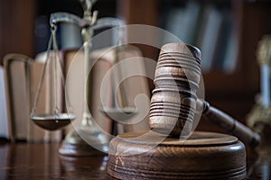 Wooden gavel on wooden table,legal books background