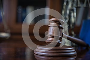 Wooden gavel on wooden table,legal books background