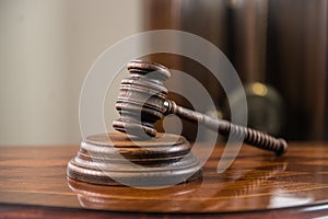 Wooden gavel on wooden table,legal books background