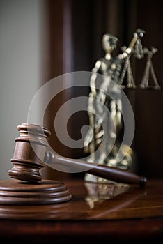 Wooden gavel on wooden table,legal books background