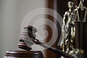 Wooden gavel on wooden table,legal books background