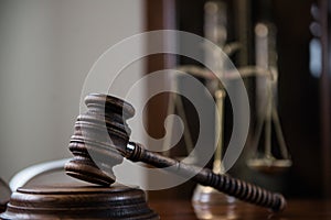 Wooden gavel on wooden table,legal books background