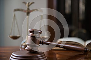 Wooden gavel on wooden table,legal books background