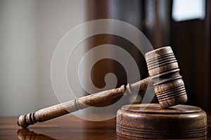 Wooden gavel on wooden table,legal books background