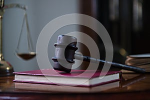 Wooden gavel on wooden table,legal books background