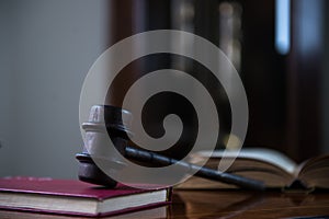 Wooden gavel on wooden table,legal books background