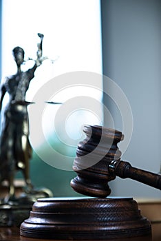 Wooden gavel on wooden table,legal books background