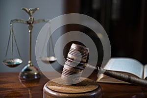 Wooden gavel on wooden table,legal books background