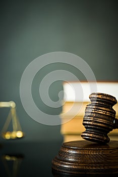 Wooden gavel on wooden table,legal books background