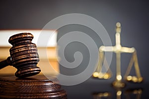 Wooden gavel on wooden table,legal books background