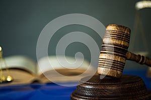 Wooden gavel on wooden table,legal books background