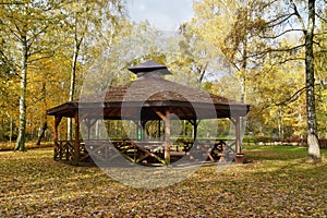 Wooden gazebo in autumn parks - relax and unwind