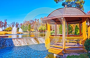 Wooden gazebo on the lake in park