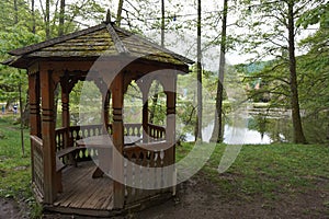 Wooden gazebo near the pond or lake