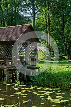 Wooden gazebo by the water for outdoor recreation. A place for a family vacation away from the bustling city. Tourism, travel to