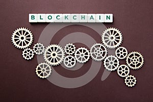 Wooden gears with word Blockchain. Cryptocurrency concept