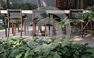 Wooden green chairs with white marble table on outside house background