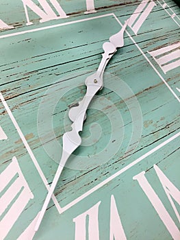 A green wall clock with white number and pointer